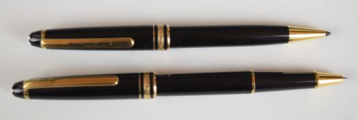 Two Montblanc Meisterstuck ballpoint pens, each with black resin body and gold plated fittings.