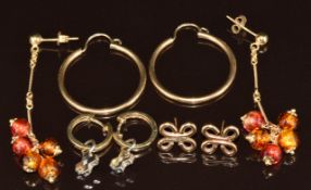 Four pairs of 9ct gold earrings, one pair bi-coloured set with a diamond, one glass beads, etc, 12.