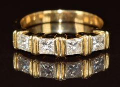 An 18ct gold ring set with four princess cut diamonds, each approximately 0.2ct each, 6.3g, size Q/