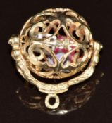 A 9ct gold charm / pendant in the form of a dice spinner with three dice inside, 5.4g