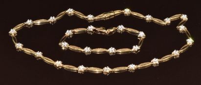 A matching 9ct gold necklace and bracelet made up of elongated and star links set with cubic