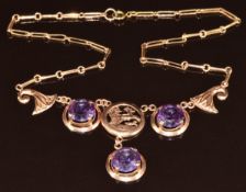 A 12k Egyptian gold necklace set with three round cut synthetic colour change sapphires