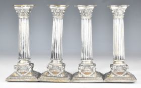 Set of four Dutch silver Corinthian column silver candlesticks having ram's head decoration to the