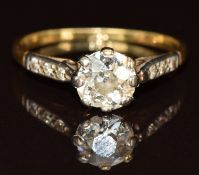 An 18ct gold ring set with a diamond of approximately 0.9ct with diamond encrusted shoulders, 2.