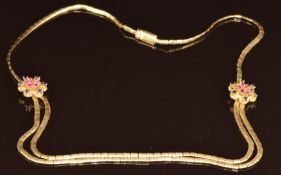 An 18ct gold necklace made up of rectangular textured links with two flower sections set with