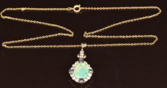 Art Deco yellow metal pendant set with an opal, sapphires and white sapphires, on yellow metal