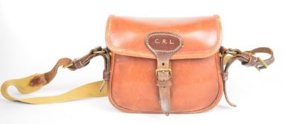 Leather 20 bore shotgun cartridge bag and belt, the bag with canvas shoulder strap and initials '
