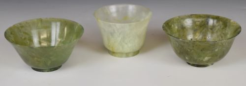 Three jade or similar hardstone pedestal dishes including a pair, largest diameter 10cm x 4.5cm