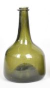 An 18thC hand blown green glass wine bottle, 18cm tall.