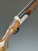 Breda 12 bore over and under shotgun with engraved locks, underside, trigger guard, top plate and