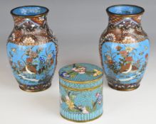 Pair of Chinese cloisonné vases and covered cannister, all decorated with flora and fauna, tallest