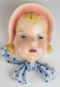 Goldscheider Art Deco wall mask plaque of a girl with bonnet, impressed and printed marks verso