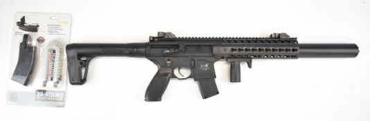 Sig Sauer MC .177 CO2 assault style air rifle with textured pistol grip, multi-shot magazine,
