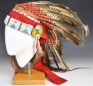 Native American headdress with bead work and buttons to front, tied in feathers and side tassels