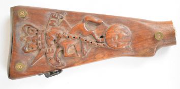 Trench art carved gun stock cribbage board with REME rearing horse motif, raised on shortened bullet