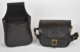 Two leather shotgun cartridge bags comprising one open carrier and one with canvas strap.