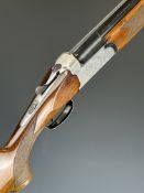 Zoli 12 bore over and under shotgun with engraved locks, underside, chequered semi-pistol grip and