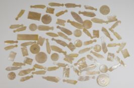 Approximately eighty mother of pearl gaming counters including fish, one marked with the ace of