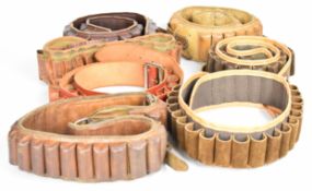 Seven leather and canvas shotgun cartridge belts.