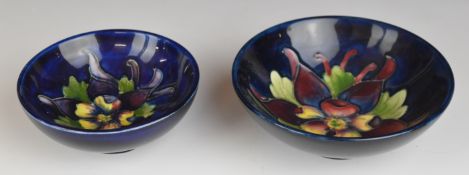 Two Moorcroft pedestal dishes decorated in the Clematis pattern, with Queen Mary paper labels to