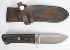 Rory Conner Irish hunting knife with composite grips and signed 10cm steel blade, in leather sheath.