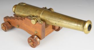 Bronze desk or signalling cannon each, 13 inch graduated barrel on wooden carriage, 35cm long.