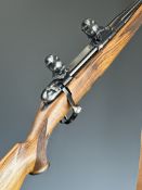 Heym .25-06 bolt-action rifle with chequered semi-pistol grip and forend, canvas sling, scope mounts