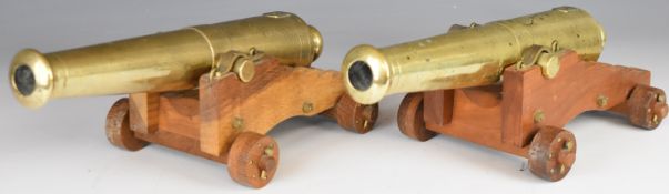 A pair of bronze desk or signalling cannon, each with 13 inch graduated barrel on wooden carriage,