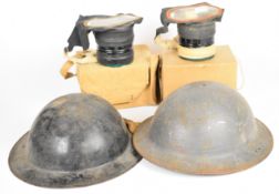 Two British WW2 Brodie steel helmets, both with liners and one with chin strap, together with two