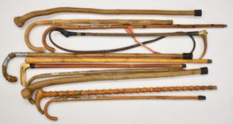 Ten various walking sticks and riding crops, one with silver mount opening to reveal a horse