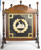 Wooden fire screen with glazed central panel wool/silk work of a sphinx superscribed Egypt inside
