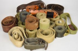 Approximately twenty canvas and leather straps / belts
