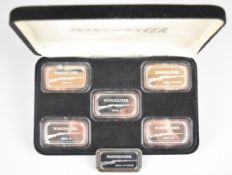 Six 1oz 999 fine silver ingots each featuring a Winchester shotgun or rifle, five in fitted case.