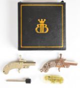A near pair of Continental miniature pinfire hammer action pistols, each with engraved metal grips