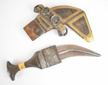 Middle Eastern Jambiya dagger with rhino or similar horn handle yellow and white metal decoration,