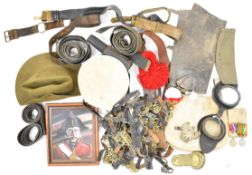 Collection of militaria including chinstraps, Sam Browne belt, haversack, picture 'The Major of