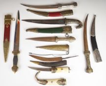 Several Oriental knives / daggers, longest blade 27cm, all with sheaths
