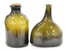 Two 18thC hand blown green glass bottles, largest 19cm tall.
