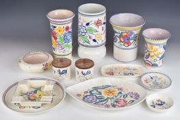 Collection of Poole pottery including four vases, dishes, trays and storage jars, one with Carter