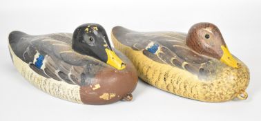 Two hand painted wooden decoy ducks each with glass eyes, largest 30cm long.