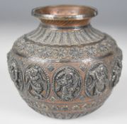 Indian footed copper and silver vase decorated with Hindu deities in relief, H8.5cm