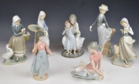 Seven Lladro figurines including ballerina, girl with umbrella and mother & daughter, tallest 25cm