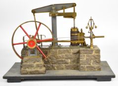 Live steam beam engine with spoked flywheel and working governor, on faux stone base with