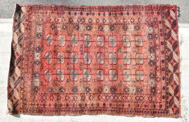 Turkoman rug with twenty four guls and geometric borders on a wine ground, 186 x 119cm