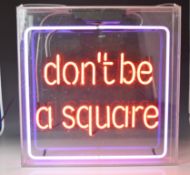 Illuminated square neon perspex sign 'don't be a square', with suspension loops, 62 x 60cm