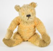Vintage Teddy bear with golden mohair, disc jointed limbs, humped back, stitched features and
