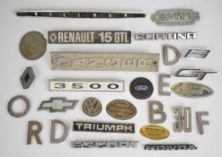 Car, lorry and other badges including Bedford in individual letters, Triumph, Ford, Cortina /
