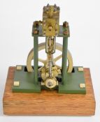 Vertical single cylinder live steam engine with spoked flywheel, on wooden base, height 23cm