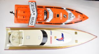 Two plastic shell radio controlled speedboats with removable tops housing two and three battery