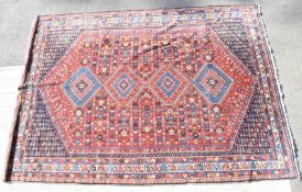 Large Persian Qashqai rug with four central lozenges on a wine ground, 316 x 224cm
